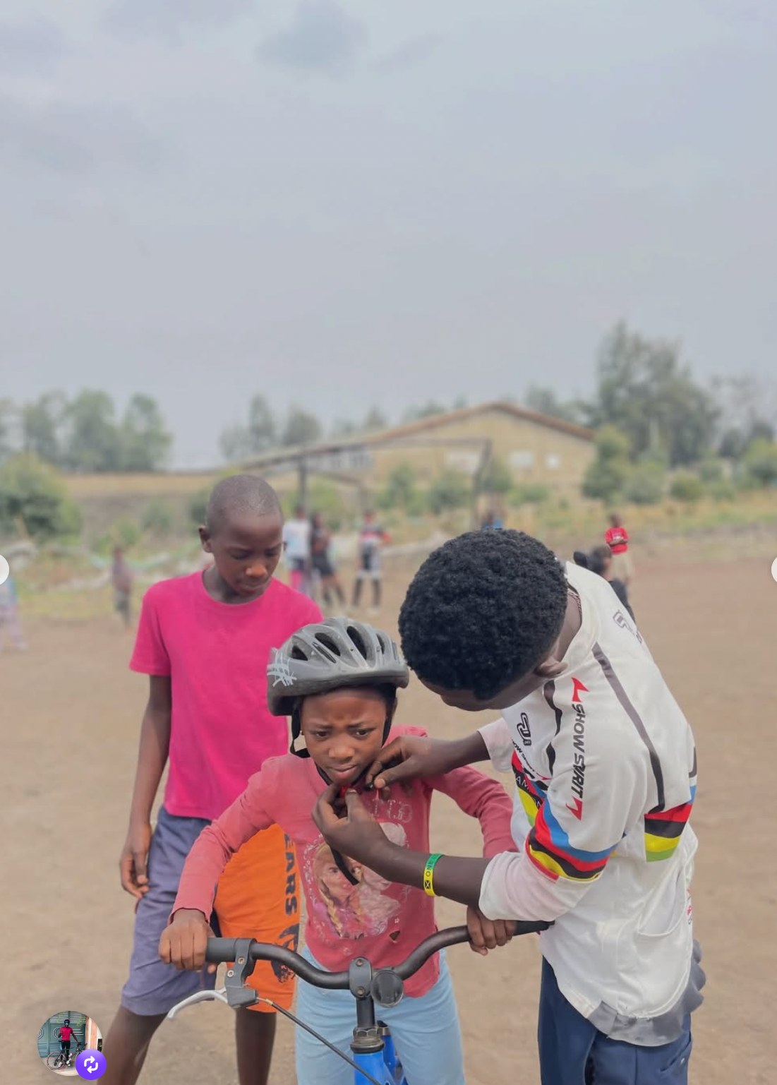 A young rider getting help fastening a helmet